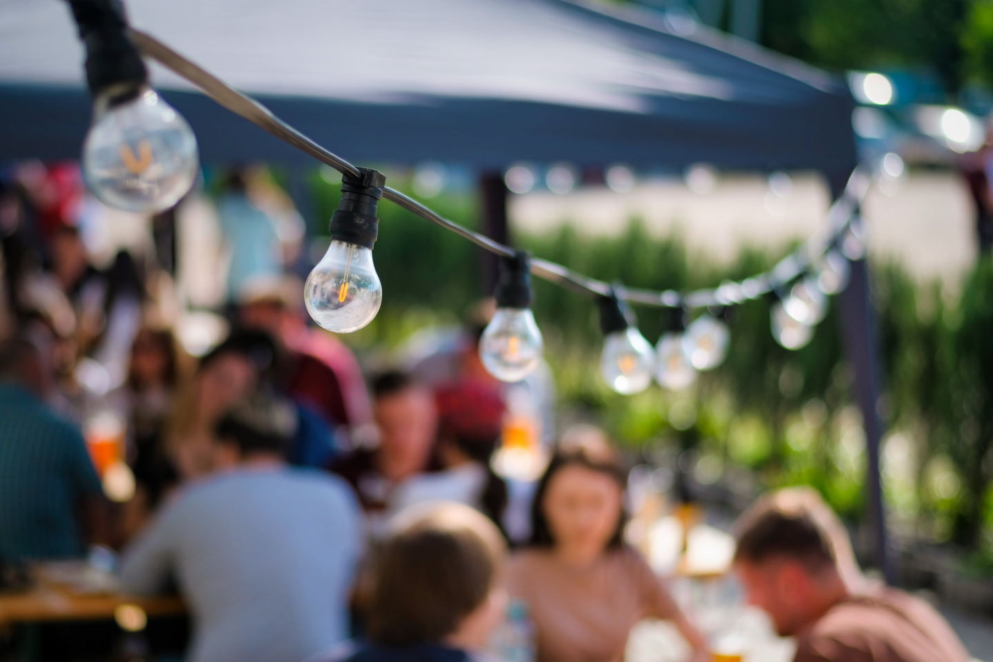 hanged-lamps-outdoor-restaurant-with-multiple-visitors-background-bbq-min.jpg